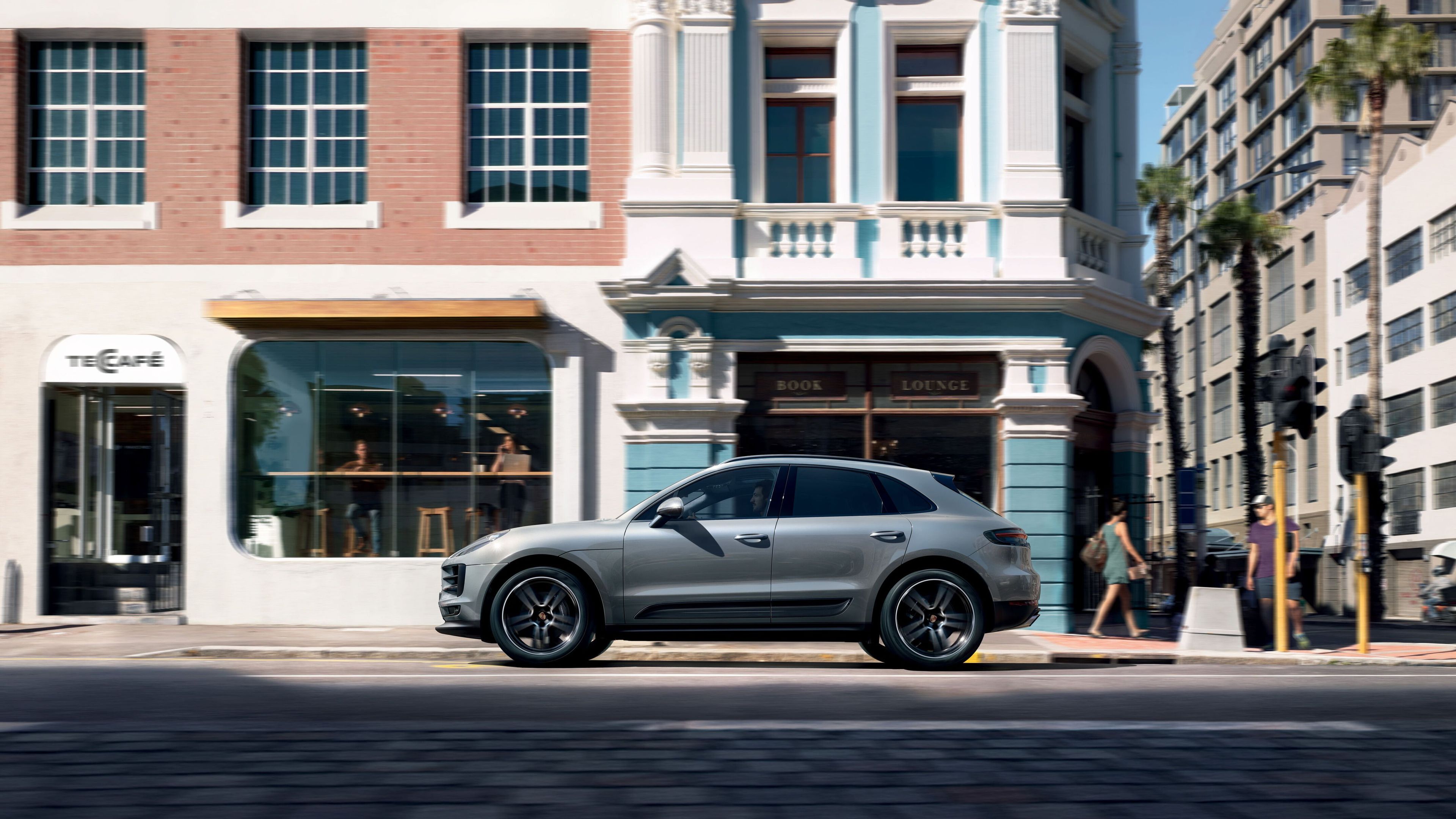 Porsche Macan in einer Stadtansicht mit einem Café im Hintergrund